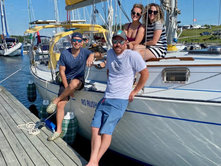 Friends and family enjoy dock time between sailing days on Cape Breton's Bras d'Or Lake, in Nova Scotia.